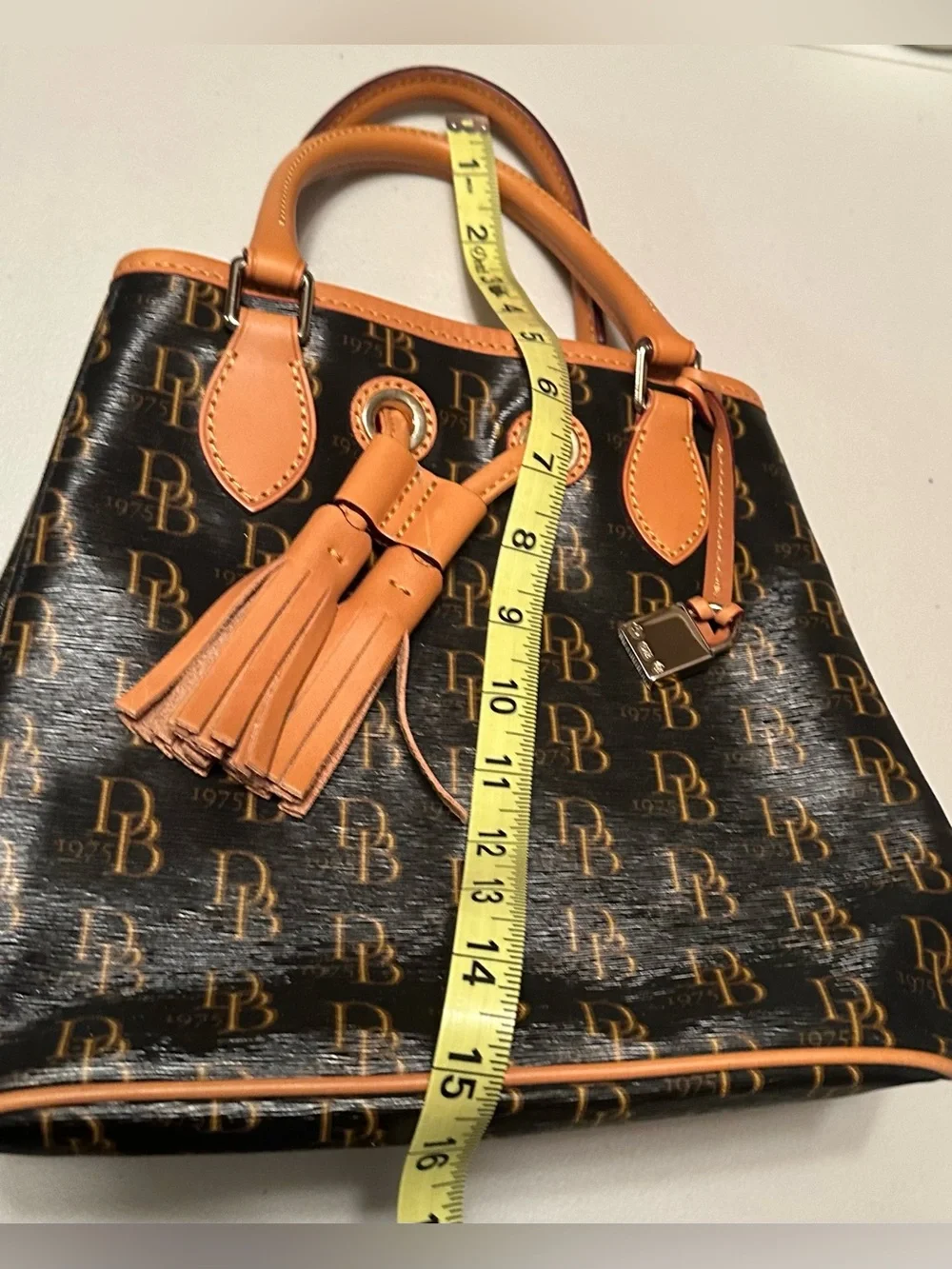 Dooney & Bourke signature brown 1975 DB logo coated canvas bucket bag